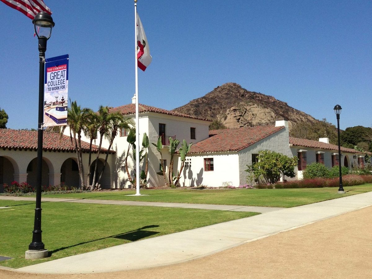 University Hall at CSU Channel Islands: white walls, red tile roofs and arches, with a rocky hill behind